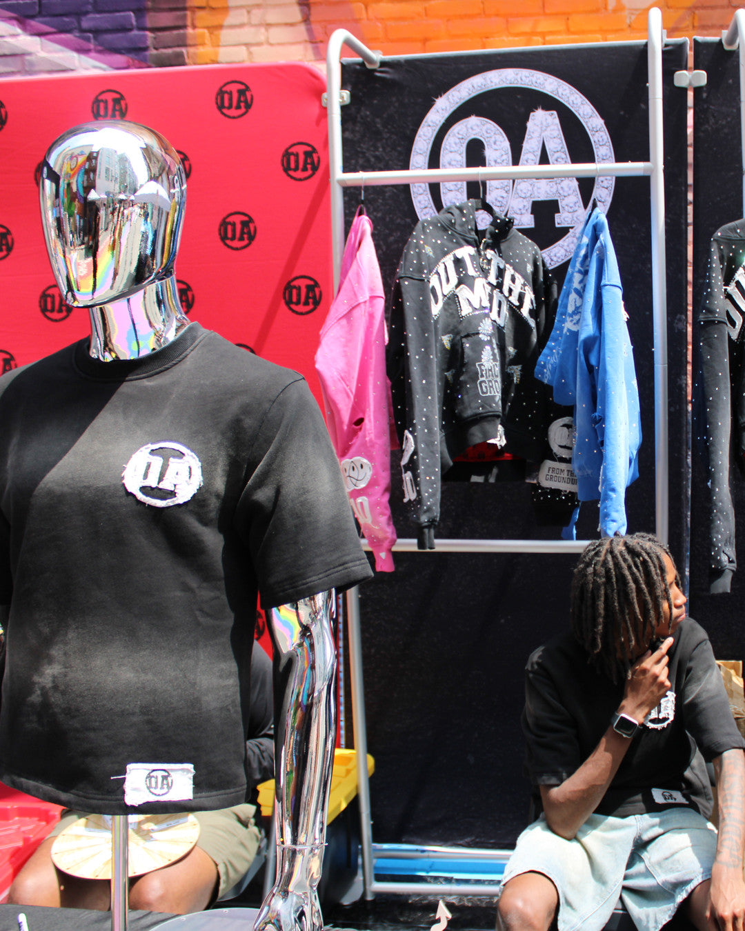 The OA pop-up booth with the Origin Blank tee on a chrome mannequin