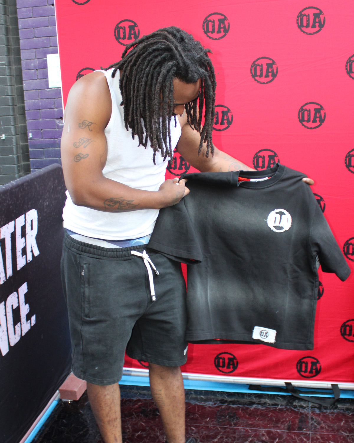 A customer checking out the Origin Blank tee at the OA pop-up